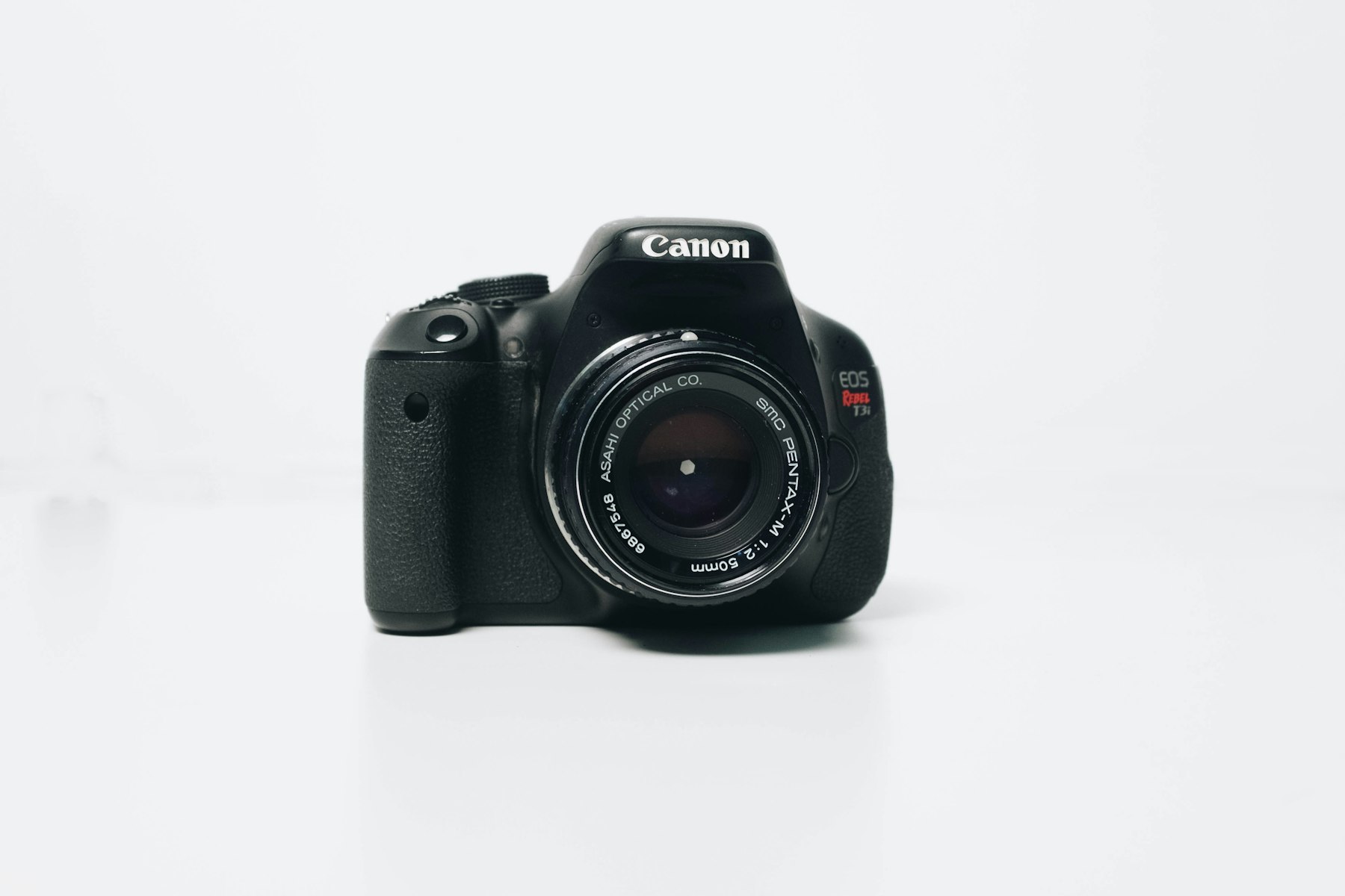 Professional camera lens photographed on a dark surface